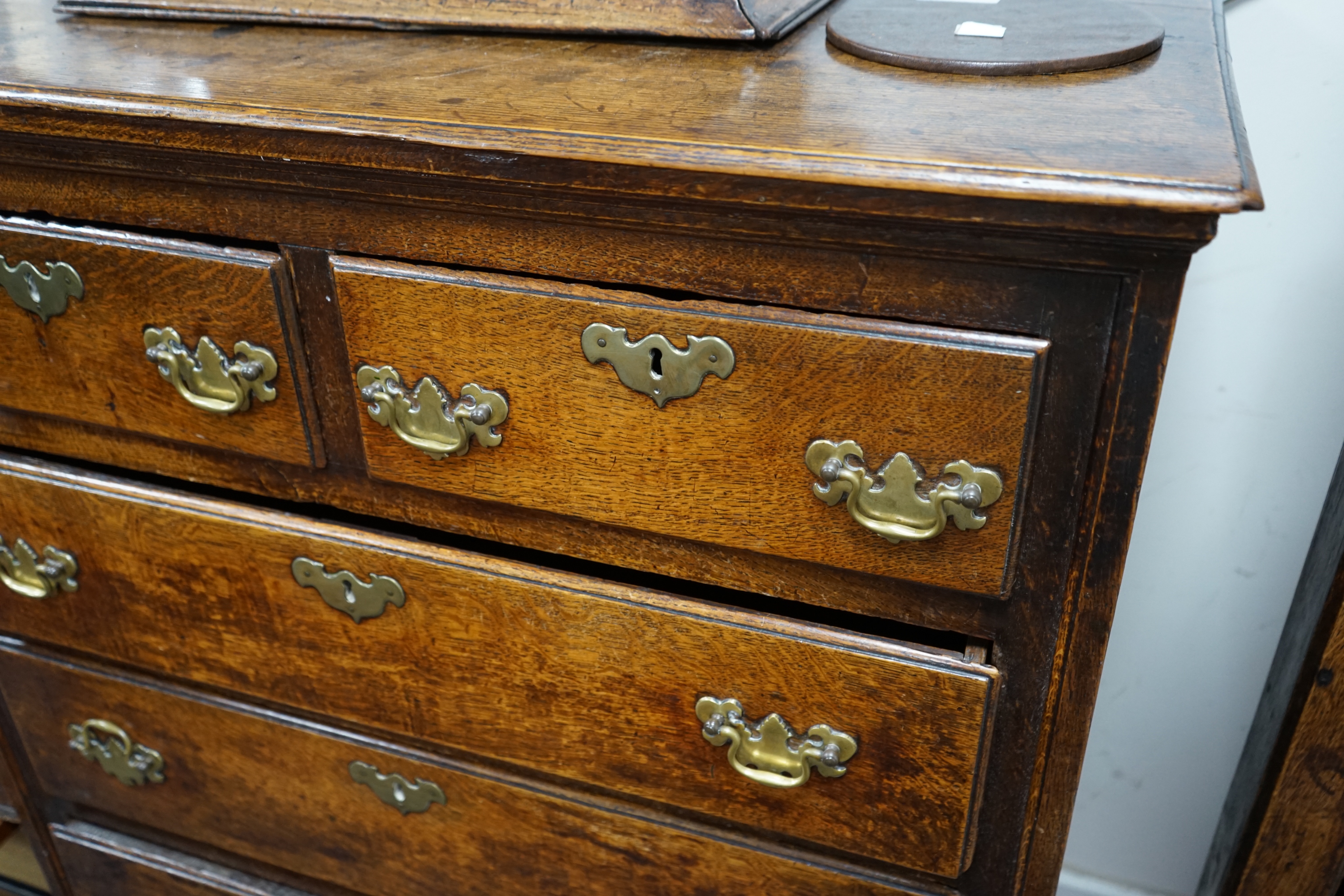 Am 18th century oak chest of two short and three long drawers fitted with brass handles, width 94cm depth 51cm height 114cm